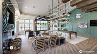 Located at 3333 Melrose Club Boulevard in Raleigh, NC, this thoughtfully designed single-floor clubhouse offers a generously proportioned communal space that blends sophisticated style with functional amenities. The expansive living room serves as the heart of the space, anchored by a striking sage-green geometric accent wall housing a linear fireplace and mounted television. Vaulted ceilings amplify the sense of openness, while large floor-to-ceiling windows flood the interior with abundant natural light and offer views of the surrounding greenery. A dramatic multi-tiered open bookshelf, suspended with green metal poles and adorned with books and trailing plants, serves as an architectural centerpiece and natural room divider. Rich herringbone-patterned hardwood flooring flows throughout, complemented by exposed dark wood beam accents that add warmth and contrast. A dedicated game area features a full-size billiards table beneath stylish pendant lighting, alongside a foosball table near the windowed wall. Dark wood structural columns frame expansive windows, creating an industrial-chic aesthetic. A quieter retreat room offers a calming sage and blush palette with natural wood paneling, a lounge chaise, and a window seat — ideal for relaxation or focused work. The hallway connects these distinct zones seamlessly, creating a cohesive and inviting environment throughout.