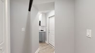 Located in Chicago's Edgewater neighborhood, this one-bedroom, one-bathroom unit at 1222 W Rosemont Ave offers a thoughtfully designed layout with modern finishes throughout. Light wood-look flooring flows seamlessly across the entire unit, creating a cohesive and clean aesthetic.

The combined kitchen and living area serves as the heart of the home. The kitchen is well-appointed with two-tone cabinetry — white upper cabinets and gray lower cabinets — complemented by white quartz countertops and a classic subway tile backsplash. Stainless steel appliances, including a range, built-in microwave, and full-size refrigerator, complete the space. Recessed lighting and exposed black piping add an industrial accent to the otherwise crisp interior.

A hallway connects the main living area to the private spaces, with the added convenience of three closets offering generous storage throughout the unit. The spacious primary bedroom features recessed lighting, soft gray walls, and a large sliding barn-style closet door, lending a modern touch to the room.

The bathroom is clean and contemporary, featuring large-format tile flooring, a gray vanity with a white countertop, and a full tub-shower combination with white tile surround. The overall ambiance of the unit is bright, modern, and move-in ready.
