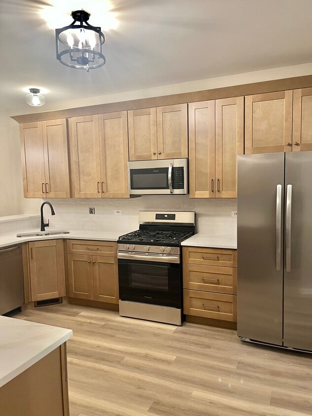 Brand new kitchen featuring new cabinets with quartz countertops. New appliances and fixtures - 17537 S Gilbert Dr