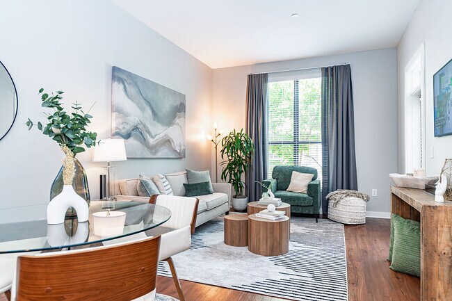 Spacious living room with hardwood-style flooring - Pine Street Flats
