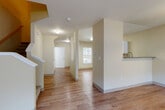 Located on Peter's Landing Lane in Marysville, WA, this two-story home offers a thoughtfully designed layout across two floors. The main level features warm hardwood-style flooring throughout the open-concept living and kitchen area. The kitchen is equipped with white shaker cabinetry, stainless steel appliances including a range, microwave, and dishwasher, complemented by grey countertops and a functional layout. The living room benefits from a large window that allows generous natural light to fill the space, and a staircase leads to the upper level. A bathroom on the main floor provides added convenience.

Upstairs, plush carpeting runs throughout the hallway landing and bedrooms. The upper floor hosts all three bedrooms, each featuring carpeted floors, neutral-toned walls, and windows with outdoor views. The generously sized primary bedroom includes its own closet and en-suite access. Two additional bedrooms share the remaining bathrooms, each fitted with vanities and hardwood-style flooring. A utility room adds functional storage to the home. Throughout, the space maintains a clean, neutral palette with cream-toned walls, creating a bright and welcoming atmosphere well-suited for comfortable everyday living.