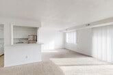 This well-appointed 3-bedroom, 2-bathroom single-floor residence in Southfield, Michigan offers a thoughtfully designed layout that balances open communal spaces with private living quarters. The combined living and dining area is generously sized, featuring plush wall-to-wall carpeting, crisp white walls, and large windows dressed with vertical blinds that flood the space with abundant natural light. The open-concept kitchen connects seamlessly to the main living area via a pass-through counter and is outfitted with stainless steel appliances — including a refrigerator, electric range, and dishwasher — complemented by ample white cabinetry and light wood-look flooring. A dedicated dining nook with its own window provides a bright and functional eating space. The spacious primary bedroom offers generous square footage, a large multi-panel closet with louvered doors, and wide windows that bring in plenty of daylight. The additional bedrooms are equally well-lit, each with carpeted floors and vertical blind-covered windows. Throughout the unit, an impressive seven closets provide exceptional storage capacity. The bathrooms feature tile flooring, with accessibility-friendly grab bars noted in one. The overall aesthetic is clean, bright, and neutral, offering a versatile canvas for a variety of living arrangements.