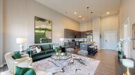 Located at 6205 Hamilton Ave in Cincinnati, Ohio, this thoughtfully designed single-floor residence combines contemporary style with functional living. The open-concept main living area immediately impresses with its soaring ceilings that amplify the sense of space, while warm hardwood-style flooring flows throughout. The living room offers generous room for comfortable seating arrangements and is bathed in natural light through large windows dressed with sheer curtains, inviting outdoor views into the interior.

The kitchen is a standout feature, outfitted with rich dark cabinetry, stainless steel appliances, a subway tile backsplash, and granite countertops. A central island with pendant lighting overhead provides additional prep space and casual seating, making it ideal for both everyday cooking and entertaining.

The bedroom is a serene retreat, featuring plush carpeting, large windows that fill the room with natural light, and ample space for generous furnishings. The bathroom complements the overall design with dark wood vanity cabinetry, granite countertops, a large mirror, and a full shower-tub combination, delivering a clean and polished finish. Throughout, the residence maintains a cohesive, modern aesthetic with neutral tones and upscale finishes that create a welcoming and refined atmosphere.