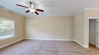Located at 3304 Green Valley Rd in Fayetteville, NC, this two-story home offers a functional and comfortable layout spread across two floors. The kitchen is a standout feature, showcasing rich wood cabinetry, granite countertops, a tile backsplash, black appliances including a range and built-in microwave, a double stainless steel sink, and light tile flooring. A pass-through counter opens the kitchen to the adjacent living area, enhancing the open feel. Natural light enters through a door with sidelights leading to the exterior. The two bedrooms are carpeted and feature ceiling fans, neutral walls with crown molding or clean trim, and built-in closets. Windows with blinds allow ample natural light and outdoor views. The three bathrooms are finished with wood vanities, white countertops, tile flooring, and tub-shower combinations. The attached garage provides direct interior access, houses the water heater, and includes an automatic opener, offering practical utility. A hallway and closet complete the layout, providing connected circulation and additional storage throughout the home.