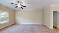 Located at 3304 Green Valley Rd in Fayetteville, NC, this two-story home offers a functional and comfortable layout spread across two floors. The kitchen is a standout feature, showcasing rich wood cabinetry, granite countertops, a tile backsplash, black appliances including a range and built-in microwave, a double stainless steel sink, and light tile flooring. A pass-through counter opens the kitchen to the adjacent living area, enhancing the open feel. Natural light enters through a door with sidelights leading to the exterior. The two bedrooms are carpeted and feature ceiling fans, neutral walls with crown molding or clean trim, and built-in closets. Windows with blinds allow ample natural light and outdoor views. The three bathrooms are finished with wood vanities, white countertops, tile flooring, and tub-shower combinations. The attached garage provides direct interior access, houses the water heater, and includes an automatic opener, offering practical utility. A hallway and closet complete the layout, providing connected circulation and additional storage throughout the home.