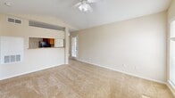 Located at 2200 Montgomery Park Blvd in Conroe, TX, this single-floor, 2-bedroom, 2-bathroom home offers a well-organized layout designed for comfortable living. The open-concept living room is a welcoming centerpiece, featuring vaulted ceilings, a ceiling fan with light kit, plush wall-to-wall carpet, and a tile-surround fireplace with a classic white mantel. Large windows allow natural light to fill the space, creating a bright and airy ambiance. A door provides direct exterior access from the living area. The kitchen connects seamlessly to the living room via a pass-through counter and is appointed with warm wood cabinetry, granite-look countertops, hardwood-style flooring, and black appliances including a range and refrigerator. Both bedrooms are generously proportioned with soft carpeting and ceiling fans. Each bedroom is paired with a dedicated walk-in closet equipped with wire shelving systems for ample storage. The two bathrooms are finished with wood-tone vanities, granite-look countertops, and tub-shower combinations with white tile surrounds. One bathroom features a bright vanity light strip above a wide mirror. The home's neutral color palette and consistent finishes throughout create a cohesive and functional living environment.