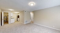 Located at 3529 Robins Landing Way in Decatur, GA, this single-floor, three-bedroom, one-bathroom home offers a practical and well-organized layout. The living area features neutral-toned carpet, textured ceilings, and flush-mount lighting, creating a clean and functional common space that opens toward the kitchen.

The kitchen stands out as a clearly updated highlight, featuring crisp white shaker cabinets with matte black hardware, light stone countertops, a classic white subway tile backsplash, and stainless steel appliances including a refrigerator, range, and over-the-range microwave. Light wood-look flooring completes the fresh, modern aesthetic.

The generously sized primary bedroom is among the largest rooms in the home, benefiting from dual windows that invite abundant natural light and outdoor views. All three bedrooms are carpeted and equipped with ceiling fans, contributing to comfortable, well-ventilated spaces. Two closets provide dedicated storage throughout the home.

The bathroom is neatly appointed with a white vanity, stone-topped counters, wood-look tile flooring, and a full tub-shower combination with tiled surround. A central hallway connects the rooms efficiently. The home's neutral color palette and consistent finishes lend a cohesive, move-in-ready feel throughout.