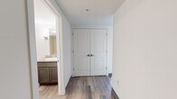 Located at 50 Morgan St in Hartford, CT, this efficiently laid-out one-bedroom, one-bathroom unit offers a clean, modern aesthetic across its single floor. Durable wood-look plank flooring runs throughout, complementing a neutral color palette of crisp whites and soft grays that creates a bright, cohesive feel.

The kitchen is well-appointed with dark espresso cabinetry, granite countertops, a tile backsplash, and a full suite of stainless steel appliances including a refrigerator, electric range, microwave, and dishwasher. A peninsula provides additional counter space and a natural transition into the open living area.

The spacious living room features large windows fitted with horizontal blinds, allowing generous natural light and views of the surrounding cityscape. A wall-mounted PTAC unit provides individual climate control.

The bedroom is a comfortable size, offering a double-door closet for ample storage and its own large window that continues the bright, airy character of the unit.

The bathroom is finished with light wood-look flooring, dark cabinetry with a granite-topped vanity, and clean white walls, presenting a tidy and functional space. A grab bar is also present, adding an accessibility-conscious detail to the design.