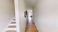 Located at 1778 Strawberry Meadows Way in Knoxville, Tennessee, this two-story home offers four bedrooms, three bathrooms, and a dedicated office across two well-organized floors. The layout distributes a more compact main level and a larger upper level, connected by a staircase with light wood treads visible from the entry hallway.

The main floor hosts the primary living areas, including an open kitchen, dining room, and living room. The kitchen features white shaker-style cabinetry, granite countertops with grey veining, stainless steel appliances, a peninsula with pendant lighting, and light hardwood flooring that carries throughout the home. The dining area is understated and bright, with neutral walls and a decorative mirror. The living room receives natural light through large windows with views of the surrounding landscape.

Upstairs, the primary bedroom is a generously sized retreat with a ceiling fan, hardwood floors, and arched interior doors. Additional bedrooms offer views of the natural surroundings through double windows. The dedicated office provides a quiet, windowed workspace. All three bathrooms feature white vanities with marble or stone-look countertops, framed mirrors, and tile flooring, maintaining a clean, consistent aesthetic throughout the home.