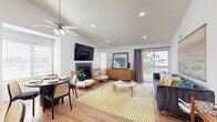 Located at 8131 E Colorado Ave in Denver, CO, this single-level 2-bedroom, 2-bathroom home offers a thoughtfully designed layout with stylish finishes throughout. The open living area is a standout, boasting soaring vaulted ceilings, recessed lighting, a ceiling fan, and a tile-surround fireplace. Large sliding glass doors lead to a private balcony, filling the space with natural light and providing outdoor views. Light wood flooring runs seamlessly through the main living areas, complementing the bright, airy atmosphere.

The kitchen features white cabinetry with gold hardware, light stone countertops, stainless steel appliances including a refrigerator and electric range, and a window above the sink for added natural light. A dining area sits adjacent to the living room, creating a cohesive and functional common space.

The primary bedroom offers a generous footprint with a large sliding-door closet, wood flooring, and in-unit laundry access. The second bedroom also includes a roomy closet and wood flooring. Both bathrooms are clean and well-finished — one with a tiled shower enclosure and dark stone vanity countertop, and the other with a full soaking tub and shower combination. A hallway connects the bedrooms and bathrooms efficiently, rounding out this comfortable Denver home.