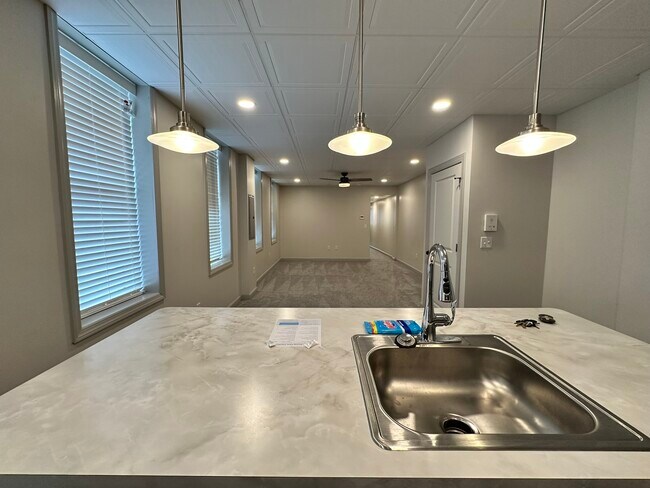 View from kitchen into living room. Coat/storage closet on right. - 158 E Walnut St