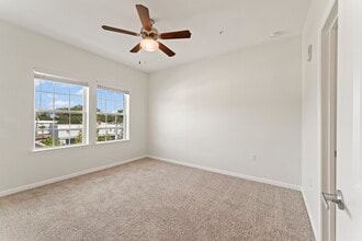 Bedroom 1 with ceiling fan, large double windows - Surf Apartments