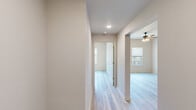 Located on Woodlawn Drive in Dublin, Georgia, this single-level 2-bedroom, 2-bathroom residence offers a clean, modern aesthetic throughout. Light wood-style flooring flows consistently across every room, creating a cohesive and bright interior ambiance.

The kitchen is a standout feature, equipped with dark shaker-style cabinetry, crisp white countertops, stainless steel appliances including a refrigerator and range, recessed lighting, and an undermount sink — all set against an open layout that connects seamlessly to the living area.

Both bedrooms are comfortably sized, with the primary bedroom offering notable square footage, a ceiling fan with light fixture, and windows that provide views of the surrounding greenery. The second bedroom mirrors this bright, airy feel with the same light flooring and neutral wall tones.

Three closets provide generous storage options, including a walk-in closet with wire shelving systems for organized storage. The two bathrooms are finished with dark vanity cabinetry, white countertops, backlit mirrors, and a soaking tub with tiled surround. Three hallways connect the layout efficiently, contributing to a functional and easy-to-navigate floor plan. The overall design is neutral, modern, and move-in ready.