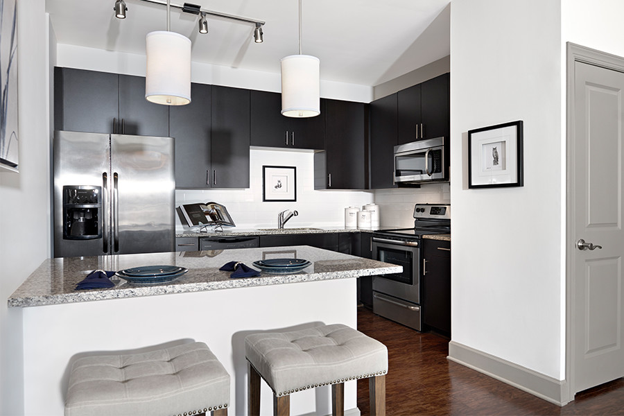 Granite countertops with subway tile backsplash - Cadence Cool Springs Apartments