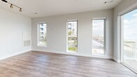 Located directly on Revere Beach Boulevard in Revere, MA, this well-appointed 2-bedroom, 2-bathroom residence offers a thoughtfully designed open-concept layout with modern finishes throughout. The combined kitchen and living area serves as the heart of the home, featuring wide-plank hardwood-style flooring, a row of tall windows that flood the space with natural light, and direct views of Revere Beach and the Atlantic Ocean. A private balcony extends the living space outdoors, offering sweeping, unobstructed ocean and beachfront views. The contemporary kitchen is equipped with white shaker cabinetry, a mosaic tile backsplash, stainless steel appliances, and a large center island with a quartz countertop and undermount sink, illuminated by sleek pendant lighting. The primary bedroom features plush carpeting and a large sliding glass door that opens to direct ocean views. The second bedroom is equally comfortable with soft carpet and ample closet access. Both bathrooms are finished with wood-look tile flooring and white subway tile — one showcasing a glass-enclosed walk-in shower, and the other a full soaking tub with shower combination. Two closets provide generous storage throughout the residence.