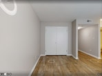 Located at 2345 7th Place Northwest in Birmingham, Alabama, this 560-square-foot, single-floor apartment offers a practical and well-organized layout comprising one bedroom, one bathroom, a kitchen, and a living room. The living area features wood-look luxury vinyl flooring, neutral beige walls, and a textured ceiling, with a large window fitted with horizontal blinds that allows ample natural light to fill the space. A front entry door opens directly into the living area, creating an open and welcoming entryway. The kitchen is outfitted with gray shaker-style cabinetry, a stainless steel sink, white countertops, and black appliances including an electric range with overhead ventilation and a full-size refrigerator. The kitchen floor continues the wood-look tile theme. The 100-square-foot bedroom is carpeted in neutral tones, features a closet with bi-fold doors, and includes a window with blinds for natural light. Textured ceilings are consistent throughout the unit. The bathroom includes a single-sink vanity with a gray cabinet base and stone-look countertop, a full-size tub-shower combo with white surround, and wood-look tile flooring. The unit's neutral color palette and updated finishes provide a clean, move-in-ready living environment.