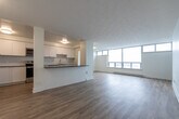 Located at 124 Park Rd N in Oshawa, Ontario, this 2-bedroom, 1-bathroom unit offers a thoughtfully designed open-concept layout with light hardwood-style flooring carried throughout the space. The kitchen is a standout feature, outfitted with crisp white cabinetry, a classic subway tile backsplash, dark contrasting countertops, and a full suite of stainless steel appliances including a refrigerator, electric range, and microwave. A peninsula counter visually connects the kitchen to the combined dining and living area, making the space ideal for everyday living and entertaining. The living room is generously sized, bathed in natural light from large floor-to-ceiling windows, and provides direct access to a private balcony with open views of the surrounding neighbourhood. The spacious primary bedroom benefits from its own large window, while the second bedroom is a comfortable size with natural light. A dedicated walk-in closet with wrap-around hanging rods and additional shelving provides ample storage. The bathroom features clean white subway tile surrounding a full soaking tub and shower combination with chrome fixtures. The unit's bright, neutral palette and modern finishes create a clean, functional living environment throughout.