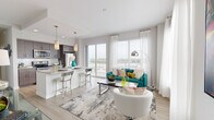 Located in the heart of Tampa, this contemporary single-floor residence offers a thoughtfully designed open-concept layout with upscale finishes throughout. The welcoming entryway features light wood-tone flooring and a round mirror, setting an elegant tone from the moment you arrive.

The living and kitchen area serves as the heart of the home, where floor-to-ceiling windows and a sliding glass door flood the space with natural light and open onto a private balcony with expansive city views. The kitchen is outfitted with dark flat-front cabinetry, a subway tile backsplash, stainless steel appliances, and a granite-topped island with bar seating, illuminated by stylish pendant lighting.

The hallways are adorned with vibrant contemporary artwork, adding personality and color throughout. The primary bedroom features bold décor accents and plush carpeting, while a second bedroom boasts a striking yellow accent wall, a built-in closet with shelving, and direct access to an ensuite bathroom. Both bathrooms are finished with granite vanity countertops, dark wood cabinetry, and clean tile work, with one featuring a full soaking tub and shower combination. This residence seamlessly blends modern urban design with comfortable, livable spaces.