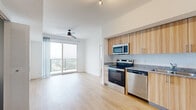 Located at 18036 Park Row Dr in Houston, TX, this modern 2-bedroom, 2-bathroom unit offers a well-designed open layout filled with natural light and contemporary finishes throughout. Light wood-tone flooring runs consistently across the entire space, complementing the clean white walls and creating a bright, cohesive aesthetic.

The kitchen is efficiently designed with light wood cabinetry, granite countertops, a neutral tile backsplash, and a full suite of stainless steel appliances including a range, microwave, dishwasher, and refrigerator. It opens directly to the living and dining area, which features a ceiling fan and access to a private balcony through sliding glass doors, offering elevated views of the surrounding Houston landscape.

Both bedrooms are well-proportioned, featuring light wood flooring and clean white walls. The primary bedroom includes sliding glass doors that open to the balcony, bringing in ample natural light and scenic outdoor views. The secondary bedroom features a window with blinds for natural light and privacy.

Each bathroom is finished with warm wood vanity cabinetry, granite countertops, large-format neutral tile surrounds in the tub/shower areas, and light wood flooring. Two dedicated closets provide practical storage. The unit also includes two closets for added convenience. The overall ambiance is clean, modern, and move-in ready.