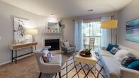 Located at 997 Johnnie Dodds Blvd in Mount Pleasant, South Carolina, this single-floor residence offers a thoughtfully designed layout that balances comfort and functionality throughout each space.

The living room serves as the heart of the home, anchored by a classic fireplace with a decorative mantle and framed by neutral walls and plush carpeting. Sliding glass doors flood the space with natural light and open directly onto a private balcony, providing a seamless indoor-outdoor connection. A separate sitting and dining area extends the living space, offering additional versatility.

The galley-style kitchen is efficiently arranged with white cabinetry, granite countertops, wood-look flooring, and stainless steel appliances, including a range, microwave, refrigerator, and dishwasher — providing everything needed for everyday cooking.

The primary bedroom is generously proportioned, featuring carpeted flooring, a large window, a dedicated workspace area, and direct access to both a walk-in closet and a private en-suite bathroom. The en-suite includes a tub-shower combination and modern vanity. A second bedroom, accented with warm-toned walls, offers comfortable accommodations, served by a second full bathroom also featuring a tub-shower combo and wood-look flooring.

The overall ambiance is bright, clean, and inviting — a practical and comfortable home in the heart of Mount Pleasant.