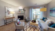 Located at 997 Johnnie Dodds Blvd in Mount Pleasant, South Carolina, this single-floor residence offers a thoughtfully designed layout that balances comfort and functionality throughout each space.

The living room serves as the heart of the home, anchored by a classic fireplace with a decorative mantle and framed by neutral walls and plush carpeting. Sliding glass doors flood the space with natural light and open directly onto a private balcony, providing a seamless indoor-outdoor connection. A separate sitting and dining area extends the living space, offering additional versatility.

The galley-style kitchen is efficiently arranged with white cabinetry, granite countertops, wood-look flooring, and stainless steel appliances, including a range, microwave, refrigerator, and dishwasher — providing everything needed for everyday cooking.

The primary bedroom is generously proportioned, featuring carpeted flooring, a large window, a dedicated workspace area, and direct access to both a walk-in closet and a private en-suite bathroom. The en-suite includes a tub-shower combination and modern vanity. A second bedroom, accented with warm-toned walls, offers comfortable accommodations, served by a second full bathroom also featuring a tub-shower combo and wood-look flooring.

The overall ambiance is bright, clean, and inviting — a practical and comfortable home in the heart of Mount Pleasant.