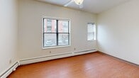 Located at 1401 Portland Ave in Minneapolis, MN, this studio unit at C104 offers a practical and efficiently designed single-floor layout. The open-concept main area seamlessly combines the living room, dining space, and kitchen, maximizing the use of available floor space. The kitchen is equipped with warm honey-toned wood cabinetry, an electric coil range, a built-in sink with countertop workspace, and a refrigerator — providing all essential cooking amenities in a compact footprint. Light wood-style flooring runs throughout the main living area, lending warmth and visual continuity to the space. Two windows in the living area allow natural light to filter in, with a ceiling fan overhead for added comfort. Baseboard heating is installed along the perimeter walls to ensure warmth during Minneapolis winters. A textured ceiling adds a classic residential character throughout. The bathroom features warm wood cabinetry, a vanity sink, a toilet, a grab bar for accessibility, and durable tile-style flooring. A dedicated closet provides convenient storage. The unit's straightforward, functional design makes it a practical option for those seeking an efficient living space in the heart of Minneapolis.