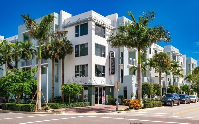 Palm-Lined Corner Entrance to South of Atlantic Luxury Apartments - South of Atlantic Luxury Apartments