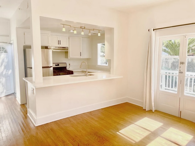 Bright open kitchen with french doors to deck - 6002 Carlton Way