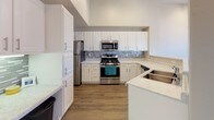 Located at 2502 Rockhurst Blvd in Colorado Springs, CO, this single-story home offers a well-designed layout with a variety of functional and comfortable spaces. The main living area is immediately notable for its vaulted ceilings, which lend an open, airy quality to the room. Soft carpet flooring, multiple windows with blinds, and a ceiling fan contribute to a bright and comfortable atmosphere. A corner fireplace serves as a focal point, while a sliding glass door provides direct outdoor access and additional natural light.

The kitchen is well-equipped with white cabinetry, light stone-look countertops, stainless steel appliances including a gas range, microwave, and refrigerator, and a stylish tile backsplash. Wood-look flooring runs throughout the kitchen, adding warmth and durability to the space.

The bedrooms feature plush carpet, ceiling fans, and generous closet space, including a walk-in closet in one room. Sliding glass doors in one bedroom offer private outdoor access. The bathrooms are finished with white vanities, stone-look countertops, wood-look flooring, and tiled tub-shower combinations, providing a clean and cohesive aesthetic throughout the home.