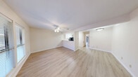 Located at 8615 Rockwood Ln in Austin, TX 78757, this one-bedroom, one-bathroom unit offers a thoughtfully laid-out single-floor plan. Light wood-style flooring runs throughout the entire space, creating a warm, cohesive aesthetic from room to room. The open living area features a ceiling fan with light fixture and windows that invite natural light, providing views of the surrounding exterior. The kitchen flows directly off the living room and is equipped with white cabinetry, stainless steel appliances including an electric range and dishwasher, a sink, and a pantry for added storage. A hallway connects the main living areas to the private bedroom, which is a generous size and also features a ceiling fan and light wood flooring. The bedroom provides direct access to the bathroom, which includes a white vanity with sink, a tiled shower-tub combo, and a clean, functional layout. A dedicated closet adds practical storage to the bedroom area. The neutral color palette of warm whites and beiges throughout the unit creates a bright, welcoming ambiance well-suited to everyday living in one of Austin's established neighborhoods.