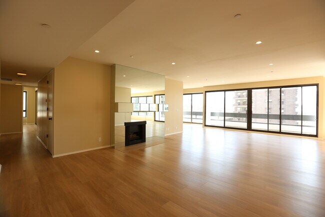 Large living room with fireplace and views - 10551 Wilshire Blvd