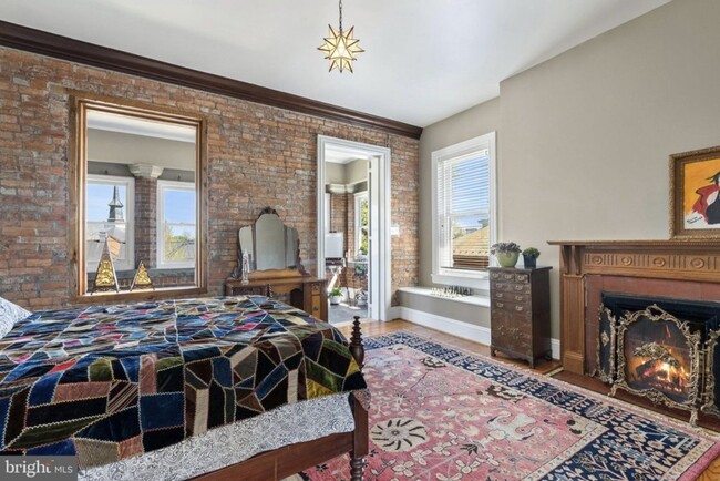 Second bedroom with exposed brick wall - 121 W Cork St