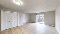 Located at 2500 Guerrero Drive in Carrollton, TX, this single-floor, 2-bedroom, 2-bathroom residence offers a clean, functional layout designed for comfortable everyday living. Light wood-style flooring flows throughout the main living areas and bedrooms, complemented by neutral gray walls and white trim that create a bright, cohesive aesthetic. Textured ceilings are consistent throughout the home.

The open living room serves as the central gathering space, featuring a sliding glass door that floods the room with natural light and provides direct access to an outdoor balcony with views of the surrounding area. The galley-style kitchen is well-appointed with gray shaker cabinetry, white quartz countertops, a classic white subway tile backsplash, a double stainless steel sink, and stainless steel appliances including a refrigerator, electric range, microwave, and dishwasher.

Both bedrooms are generously proportioned, each equipped with a ceiling fan with light fixture and a window that invites natural light. The two bathrooms mirror one another in design, each featuring a full soaking tub, a tub-surround clad in large-format gray stone-look tile, and chrome fixtures. Two dedicated closets provide ample storage throughout the home.