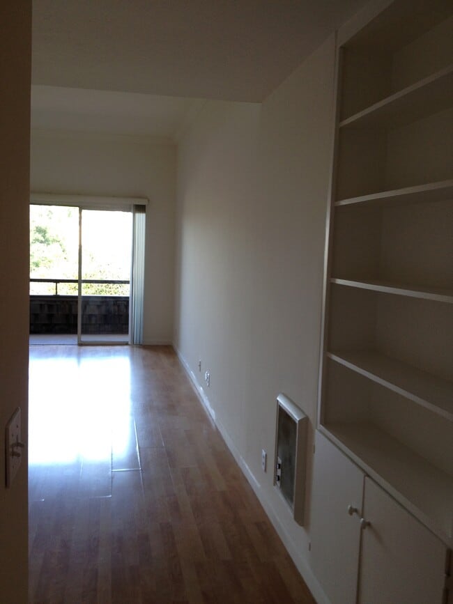 Living room building bookcase and wood floors crown molding high ceilings - 696 Athol Ave