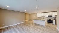 Located at 727 Salem Church Rd in Newark, Delaware, this well-appointed single-floor home offers three bedrooms, two bathrooms, and a thoughtfully designed layout. Light-toned luxury vinyl plank flooring flows throughout, creating a cohesive and clean aesthetic across every room.

The heart of the home is a spacious open-concept area combining the living room, dining room, and kitchen. The kitchen stands out with crisp white shaker cabinetry, granite countertops, a tile backsplash, a large center island with pendant lighting, and a full suite of stainless steel appliances. Sliding glass doors in the living area invite natural light and provide outdoor access.

A central hallway connects the private bedroom wing to the main living spaces. The generously sized primary bedroom offers ample room to furnish comfortably. Additional bedrooms include ceiling fans and double-door closets. With seven closets total, storage is plentiful throughout.

Both bathrooms mirror the home's modern finishes, featuring white cabinetry, granite-topped vanities, and light flooring. One bathroom includes a tub-shower combo with built-in shelving. A dedicated laundry room and utility room add practical convenience. Recessed lighting throughout enhances the bright, welcoming ambiance of this move-in ready home.