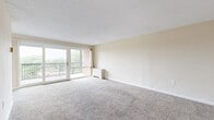 Located at 8484 16th St in Silver Spring, MD, this two-bedroom, two-bathroom residence offers a well-designed single-floor layout with a comfortable and functional living environment. The spacious living room is carpeted and bathed in natural light, featuring large sliding glass doors that open to a private balcony overlooking lush greenery — a standout feature that brings the outdoors in. The kitchen is thoughtfully appointed with rich cherry wood cabinetry, granite-style countertops, a mosaic tile backsplash, stainless steel appliances including a gas range, microwave, and refrigerator, and durable hardwood-style flooring. The generously sized primary bedroom includes a ceiling fan, plush carpet, and access to a dedicated walk-in closet with built-in shelving and hanging rods. The second bedroom also features a ceiling fan and large window, filling the room with natural light. Both bathrooms are finished with clean white subway tile surrounds and full soaking tubs. Five closets throughout the residence provide exceptional storage capacity. A connecting hallway ties the layout together seamlessly, creating a practical and well-organized flow throughout the home.