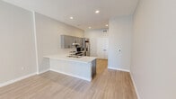Located at 608 2nd Ave S in downtown Minneapolis, this 3-bedroom, 4-bathroom unit offers a well-designed single-floor layout with contemporary finishes throughout. Light wood-style flooring flows consistently across all rooms, creating a bright and cohesive aesthetic complemented by neutral gray and white tones on the walls.

The open kitchen and living area serves as the heart of the unit, featuring gray shaker-style cabinetry, white quartz countertops, a subway tile backsplash, and a full suite of stainless steel appliances including a range, microwave, and French door refrigerator. A double-door closet provides generous storage adjacent to the kitchen.

Each of the three bedrooms offers a calm, minimalist atmosphere with large windows that invite natural light and frame views of the downtown Minneapolis skyline. The primary bedroom includes its own closet with built-in wire shelving. The four bathrooms are finished with gray vanities matching the kitchen cabinetry, illuminated mirrors with sleek black fixtures, and white tile tub-shower combinations. At least one bathroom is equipped with ADA-accessible grab bars, reflecting thoughtful accessibility design throughout.

The unit's clean, modern aesthetic, functional layout, and prime downtown location make it a practical and refined urban living space.