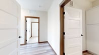 Located at 5401 94th Ave N in Brooklyn Park, Minnesota, this well-appointed 2-bedroom, 2-bathroom residence offers a thoughtfully designed single-level layout with a clean, modern aesthetic. Light-toned hardwood-style flooring runs through the main living areas, creating a bright, cohesive feel, while warm wood door casings and baseboards add a refined contrast throughout the hallways and common spaces.

The open kitchen is a standout feature, showcasing white shaker cabinetry with black hardware, granite countertops, a classic subway tile backsplash, and a full suite of stainless steel appliances including a side-by-side refrigerator, dishwasher, microwave, and range. A center island with additional storage provides extra prep space and a natural gathering point.

The living area is generously sized, filled with natural light from large windows and a sliding glass door that opens to a private balcony with outdoor views of the surrounding neighborhood. Both bedrooms feature plush carpeting, large windows, and ceiling fans. The spacious primary bedroom includes a walk-in closet outfitted with wire shelving systems for versatile storage. Each bathroom features granite-topped white vanities and hardwood-style tile flooring, with a walk-in shower in the secondary bath.