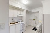 Located at 280 Sierra Dr in Miami, FL, this one-bedroom, one-bathroom residence offers a thoughtfully designed layout across a single floor. The interior is characterized by a clean, bright aesthetic, with crown molding and light tile flooring flowing consistently throughout the space.

The kitchen is fully appointed with white cabinetry, a double-basin sink, and a full suite of appliances including a refrigerator, electric range, and ample counter space. A small dining area with bar-height seating adjoins the kitchen, making it ideal for casual meals.

The living area, composed of two connected spaces, provides a comfortable and versatile setting with room for both lounging and entertaining. Crown molding accents the ceilings, adding a refined architectural touch, while natural light filters in to create a warm ambiance.

The bedroom is a well-proportioned retreat featuring a window with outdoor greenery views, crown molding, and direct access to a dedicated closet with hanging storage. The soft, neutral color palette contributes to a calm and restful atmosphere.

The bathroom is finished with large-format stone-look tile on the walls and a shower/tub combination, lending a clean, polished appearance. A connecting hallway ties all rooms together efficiently, completing this well-organized and stylish Miami residence.