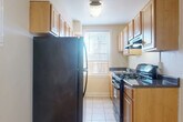 Located at 5324 Rock Creek Church Rd NE in Washington, DC, this one-bedroom, one-bathroom unit offers a well-organized and functional layout across a single floor. Warm parquet hardwood flooring flows throughout the living areas, hallways, and bedroom, adding classic character to the space. The open living room features crown molding, a ceiling fan, and a wall-mounted AC unit, while an adjacent dining area is accented by an elegant chandelier and connects seamlessly to the kitchen. The galley-style kitchen is well-appointed with rich dark wood cabinetry, light granite countertops, stainless steel appliances including a gas range, a built-in skylight panel, and tile flooring — all complemented by a window that brings in natural light. The spacious bedroom includes multiple closets, a ceiling fan, and its own wall-mounted AC unit, providing comfort and generous storage. The bathroom is bright and clean, featuring white tile flooring, a soaking tub, and a large window. Two hallways connect the spaces efficiently, and four closets throughout the unit ensure plentiful storage. This well-maintained residence offers a practical and comfortable living environment in a desirable DC neighborhood.