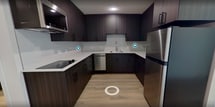 This 340 square foot studio apartment in Salt Lake City, Utah, offers a thoughtfully designed living space on a single floor. The interior showcases a contemporary aesthetic with a neutral color palette and modern finishes throughout. The open-concept layout maximizes the use of space, seamlessly blending the living area with the kitchen.

The kitchen is a standout feature, boasting dark wood cabinetry that contrasts beautifully with white quartz countertops. Stainless steel appliances, including a refrigerator and dishwasher, add a sleek touch. A white tile backsplash and under-cabinet lighting enhance the kitchen's modern appeal.

The bathroom is efficiently designed with a white toilet, shower area, and a towel bar. It maintains the apartment's cohesive look with light-colored walls and wood-look flooring. The main living area is bright and airy, benefiting from a large window that allows natural light to flood the space and offers views of the surrounding area.

Throughout the apartment, wood-look flooring adds warmth and continuity. The walls are painted in a crisp white, creating a sense of spaciousness. Recessed lighting in the kitchen and bathroom provide ample illumination. Despite its compact size, the apartment's clever design ensures a comfortable and functional living environment.