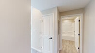 Located at 164 Blossom St in Lynn, Massachusetts, this thoughtfully designed single-floor residence offers a cohesive blend of modern finishes and functional layout. Light-toned luxury vinyl plank flooring runs throughout, complementing the warm neutral wall tones and crisp white trim that define the interior aesthetic.

The kitchen serves as a central highlight, featuring gray shaker-style cabinetry with matte black hardware, white countertops, and a full suite of stainless steel appliances including a refrigerator, range, built-in microwave, and dishwasher. Recessed lighting illuminates the space, which flows openly into the adjacent living and dining areas.

The living and dining areas are generously proportioned, with multiple large windows dressed with horizontal blinds that invite abundant natural light and offer views of the surrounding Lynn cityscape. Crown molding adds a refined detail to these shared spaces.

The bedroom is well-sized, featuring crown molding, a closet with a paneled white door fitted with sleek black hardware, and a neutral palette ready for personalization. The bathroom is clean and functional, equipped with a full tub-shower combination, recessed lighting, and light wood-toned flooring. A hallway with a paneled interior door and utility access panel provides practical connectivity between the rooms.