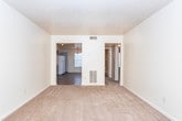 Located in Columbus, Georgia, this single-floor residence offers a straightforward and functional layout spread across several well-defined living spaces. The interior is finished with a neutral, cream-toned color palette throughout, creating a clean and consistent aesthetic from room to room.

The living areas feature wall-to-wall carpeting in a warm beige tone, providing a soft and comfortable feel underfoot. Natural light filters in through multiple windows fitted with blinds, keeping the rooms bright and airy. Textured ceilings add a subtle design element throughout the space.

The kitchen is equipped with dark wood-toned cabinetry extending both above and below the countertops, offering generous storage. The countertops are finished in a retro orange laminate, complemented by a double-basin sink and a coil-top electric range with an overhead ventilation hood. The kitchen floor is covered in durable vinyl tile.

The bedrooms are carpeted and well-proportioned, each featuring windows that bring in natural light. The rooms are designed with simplicity in mind, offering a blank canvas for personalization.

The bathroom includes a full tub and shower combination surrounded by classic beige square ceramic tile, with chrome fixtures providing a clean, functional finish.

Overall, this home presents a practical and livable layout suited for comfortable day-to-day living in Columbus, GA.