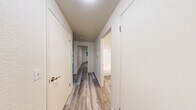 Located at 1305 W Casino Rd in Everett, WA, this one-bedroom, one-bathroom unit offers a well-organized single-floor layout with modern updates throughout. Light gray vinyl plank flooring runs continuously across all rooms, creating a cohesive and easy-to-maintain interior.

The living room is a standout space, anchored by a fireplace and a sliding glass door that opens to a private balcony with views of surrounding greenery. A baseboard heating system provides additional comfort. The open sightline into the kitchen makes the living area feel connected and functional.

The kitchen features a galley-style layout with white shaker cabinets, light quartz countertops, a stainless steel sink, and a full suite of appliances including a refrigerator, range, and dishwasher — offering ample storage and prep space in an efficient footprint.

The bedroom is a comfortable size, equipped with a sliding double-door closet and a window that brings in natural light and garden views. A baseboard heater ensures year-round warmth.

The bathroom includes a full tub-shower combination with white tile surround, finished in a clean, straightforward style. Throughout the unit, neutral walls and consistent flooring contribute to a bright, move-in ready atmosphere ideal for everyday living.