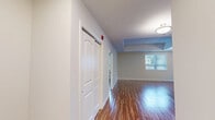 Located at 570 Park Avenue West in Chatham-Kent, Ontario, this well-appointed 2-bedroom, 2-bathroom unit offers a comfortable and functional single-floor layout. Warm hardwood-style flooring flows consistently throughout, complementing the neutral, light-toned walls that lend a clean and airy feel to every room.

The open-concept kitchen and living area serves as the heart of the unit. The kitchen is outfitted with rich dark-stained cabinetry, stainless steel appliances including a refrigerator, range, and over-the-range microwave, stone-look countertops, and a classic white subway tile backsplash — a practical and stylish space for everyday living.

The primary bedroom offers a generous footprint with tray ceiling detailing and ample room for furnishings. The second bedroom receives excellent natural light through large windows with views of the surrounding neighbourhood. Both bathrooms are finished in crisp white, with one featuring a full soaker tub and shower combination, and the other a walk-in shower with built-in shelving.

A dedicated in-unit laundry room with side-by-side washer and dryer adds everyday convenience. The private balcony, framed by a sleek glass railing, overlooks a well-maintained landscaped courtyard — a pleasant outdoor retreat within a residential community setting.