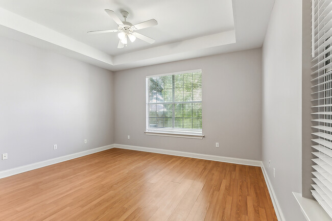 Spacious primary bedroom features two walk-in closets, tray ceiling and tons of natural light. - 3245 Iowa Ave