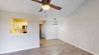 Located at 2500 W 5th St in Greenville, North Carolina, this single-floor residence offers a well-designed layout with a range of thoughtful details throughout. The living area greets you with soaring vaulted ceilings, wood-look luxury vinyl plank flooring, and a ceiling fan that enhances the open, airy feel. A large window allows natural light to fill the space, while a bold dark front door adds character to the entryway. The dining area features a stylish pendant light fixture, and a pass-through connects seamlessly to the kitchen. The kitchen is outfitted with white cabinetry, subway tile backsplash, light countertops, a stainless steel sink, and full-size stainless steel appliances, including a refrigerator and dishwasher. The primary bedroom impresses with vaulted ceilings, plush carpeting, a walk-in closet, and direct access to a private outdoor deck with views of surrounding greenery. An en-suite bathroom is conveniently accessible from the bedroom. Additional bedrooms are carpeted and feature windows that bring in natural light. The bathroom includes a full tub and shower combination. Throughout the home, neutral tones and clean finishes create a cohesive and comfortable living environment.