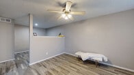 Located at 12250 Abrams Rd in Dallas, TX, this efficiently designed single-floor unit offers a well-utilized layout comprising a living room, kitchen, bathroom, and utility room. Wood-look plank flooring flows consistently throughout the space, lending a cohesive and contemporary feel to every room.

The living room is bright and inviting, featuring a ceiling fan with light fixture, a textured ceiling, and windows dressed with blinds that allow natural light to filter in. The neutral gray wall tones create a clean, versatile backdrop.

The kitchen is thoughtfully appointed with gray shaker-style cabinetry, marble-patterned countertops, a double-basin stainless steel sink, and a white appliance suite that includes a refrigerator, electric range, and dishwasher. The light tile flooring complements the cabinetry for a polished look.

The bathroom is accessed via a short hallway and features a dark-toned vanity with storage drawers, a well-lit mirror, and consistent tile flooring that ties into the rest of the unit. A textured ceiling adds architectural detail overhead.

A utility room provides additional functional space, rounding out the practical offerings of this unit. The overall ambiance is clean, modern, and move-in ready, making it a functional and attractive space in the Dallas area.