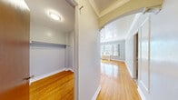 Located at 600 James St in Syracuse, NY, this one-bedroom, one-bathroom unit offers a well-organized layout across a single floor. The living room is a standout space, featuring warm hardwood floors, soft blue-gray walls with elegant paneled molding details, and a large bank of multi-pane windows that flood the room with abundant natural light while offering views of the surrounding cityscape and treetops. A classic radiator beneath the windows adds to the architectural character of the space.

The bedroom mirrors the living room's aesthetic, continuing the hardwood flooring and blue-gray palette, with its own generous windows framing bright outdoor views and decorative wall molding that lends a refined, classic feel.

The galley-style kitchen is efficiently designed with white cabinetry lining both sides, light granite-style countertops, a stainless steel sink, and full-size appliances including a refrigerator and range. The marble-pattern tile flooring adds a touch of elegance to the compact, functional space.

The bathroom features classic small-tile mosaic flooring, a vanity with storage, and a clean, straightforward layout. Throughout the unit, the blend of original architectural details and updated finishes gives the space a timeless, practical character well-suited to urban living in downtown Syracuse.