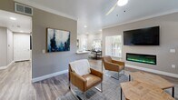 Located at 10270 E Taron Dr in Elk Grove, CA, this single-story 2-bedroom, 3-bathroom home offers a thoughtfully designed layout with modern finishes throughout. The open-concept living area is a standout, featuring wood-look flooring, crown molding, recessed lighting, and a sleek wall-mounted electric fireplace flanked by windows that invite natural light. The kitchen is outfitted with crisp white shaker cabinets, a subway tile backsplash, stainless steel appliances including a refrigerator, range, microwave, and dishwasher, and durable wood-look flooring. The primary bedroom offers a comfortable retreat with plush carpeting, a ceiling fan, and access to natural light through a window. A mirrored sliding closet door adds a sense of depth to the secondary bedroom. The three bathrooms include units with tub-shower combinations — one featuring a soaking tub with chrome fixtures and a built-in caddy, and another with a classic tub and shower curtain setup. Neutral warm-gray tones carry throughout the home, creating a cohesive and calming ambiance well-suited for everyday living.